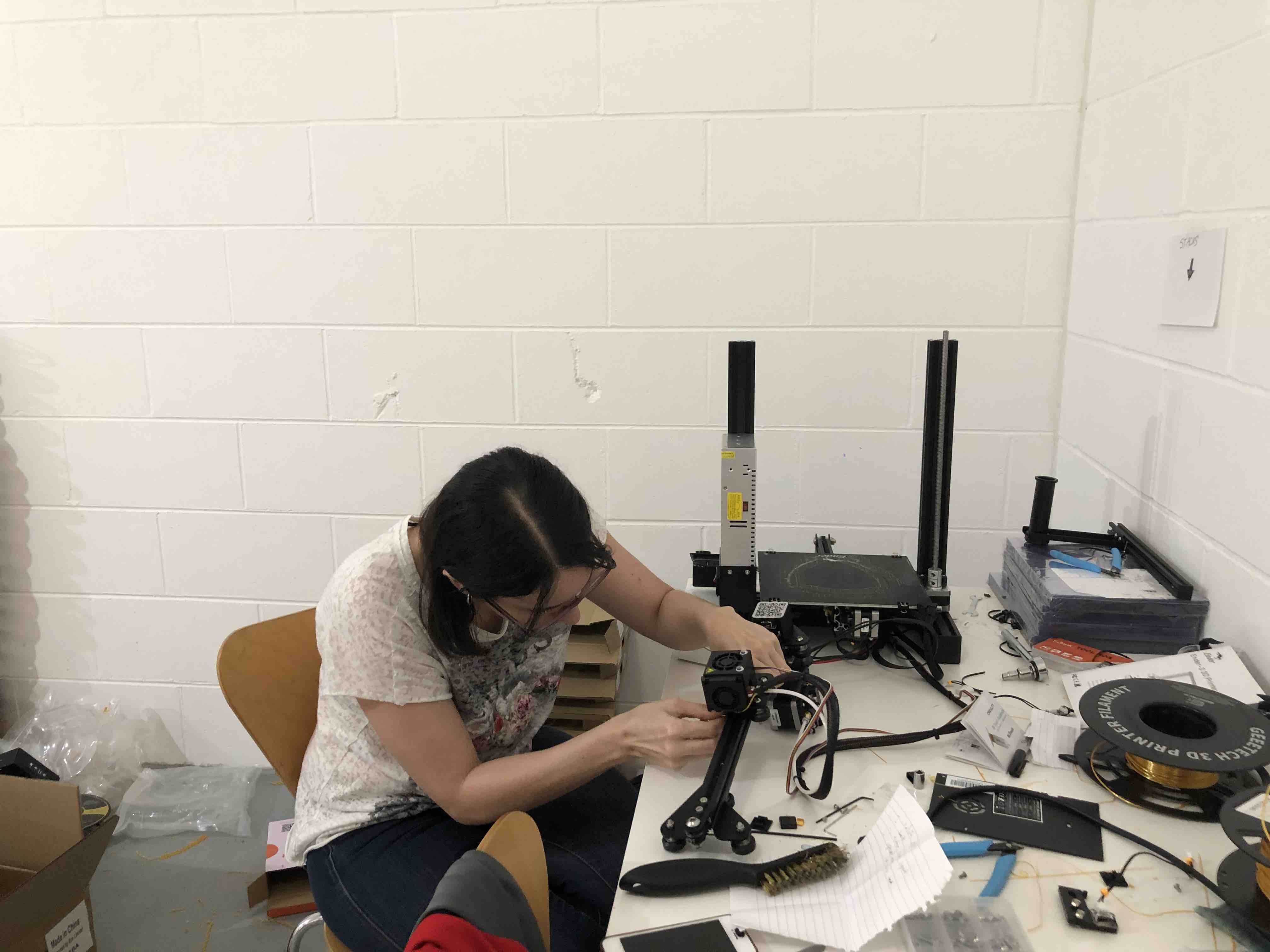 Filament spools and printer parts during maintenance