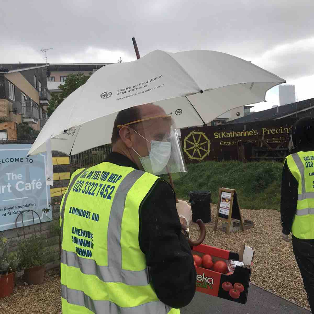 Volunteers wearing our face shields while providing food aid