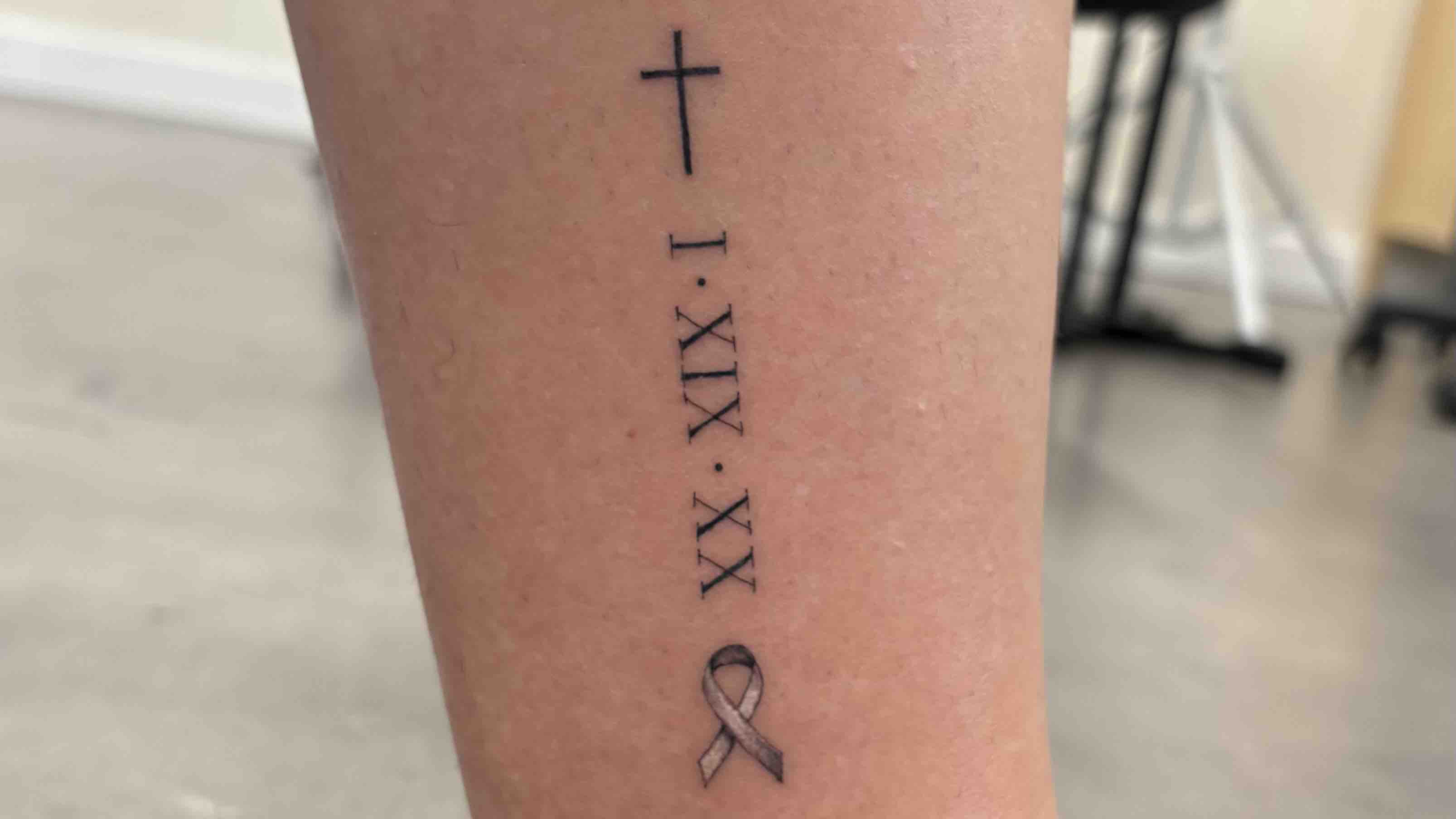 Cross Tattoo with Roman Numerals: A Symbol of Strength