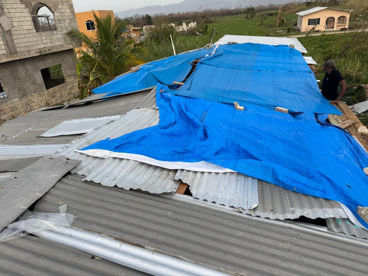 This is to help Assaney and his family rebuild their roof campaign photo, 7 of 8