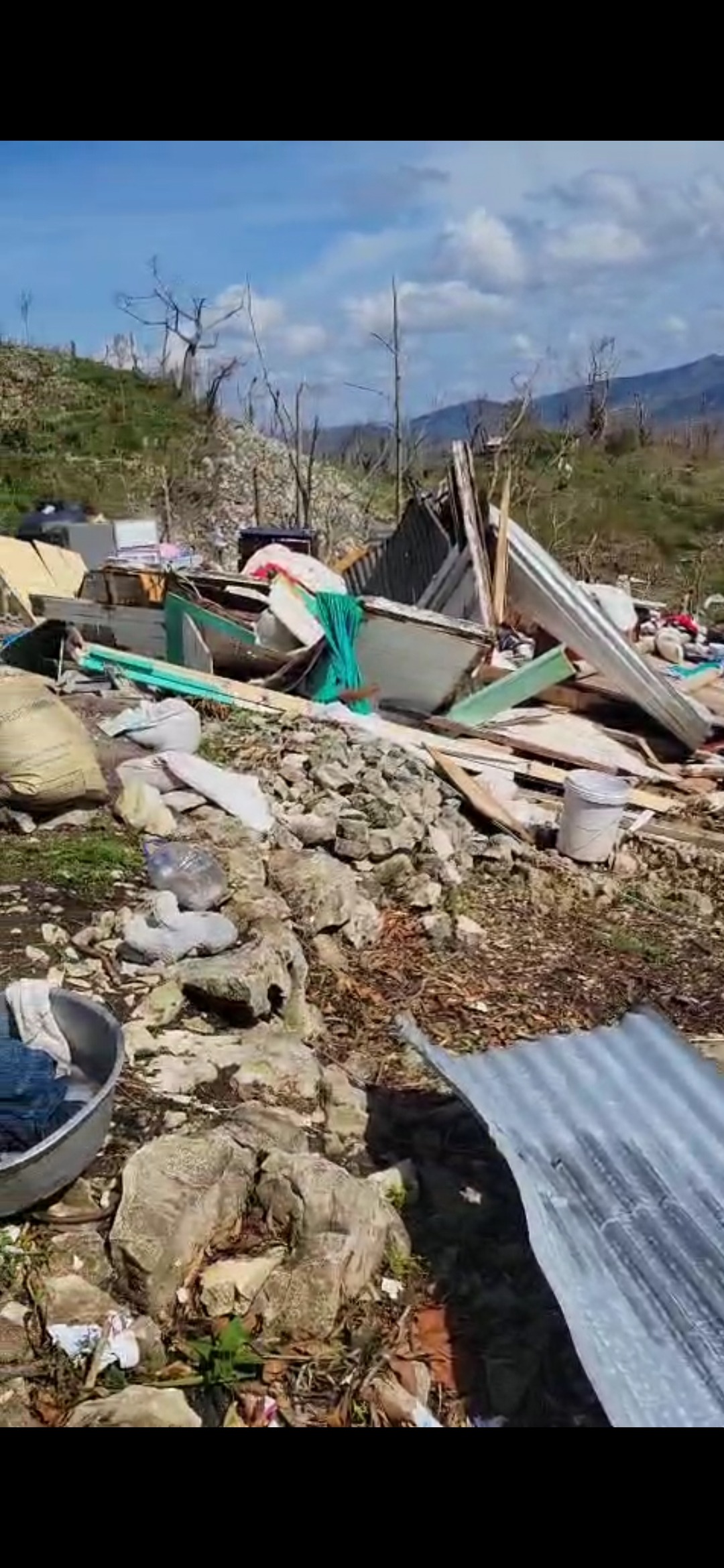 A elderly family who lost their home to hurricane Melissa campaign photo, 5 of 6