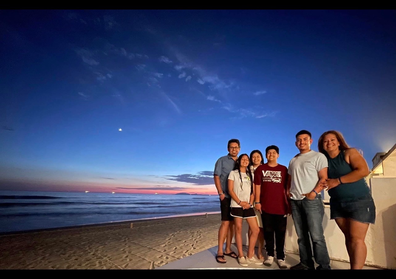 Standing with Vanessa and her kids in their Time of Need campaign photo, 4 of 8